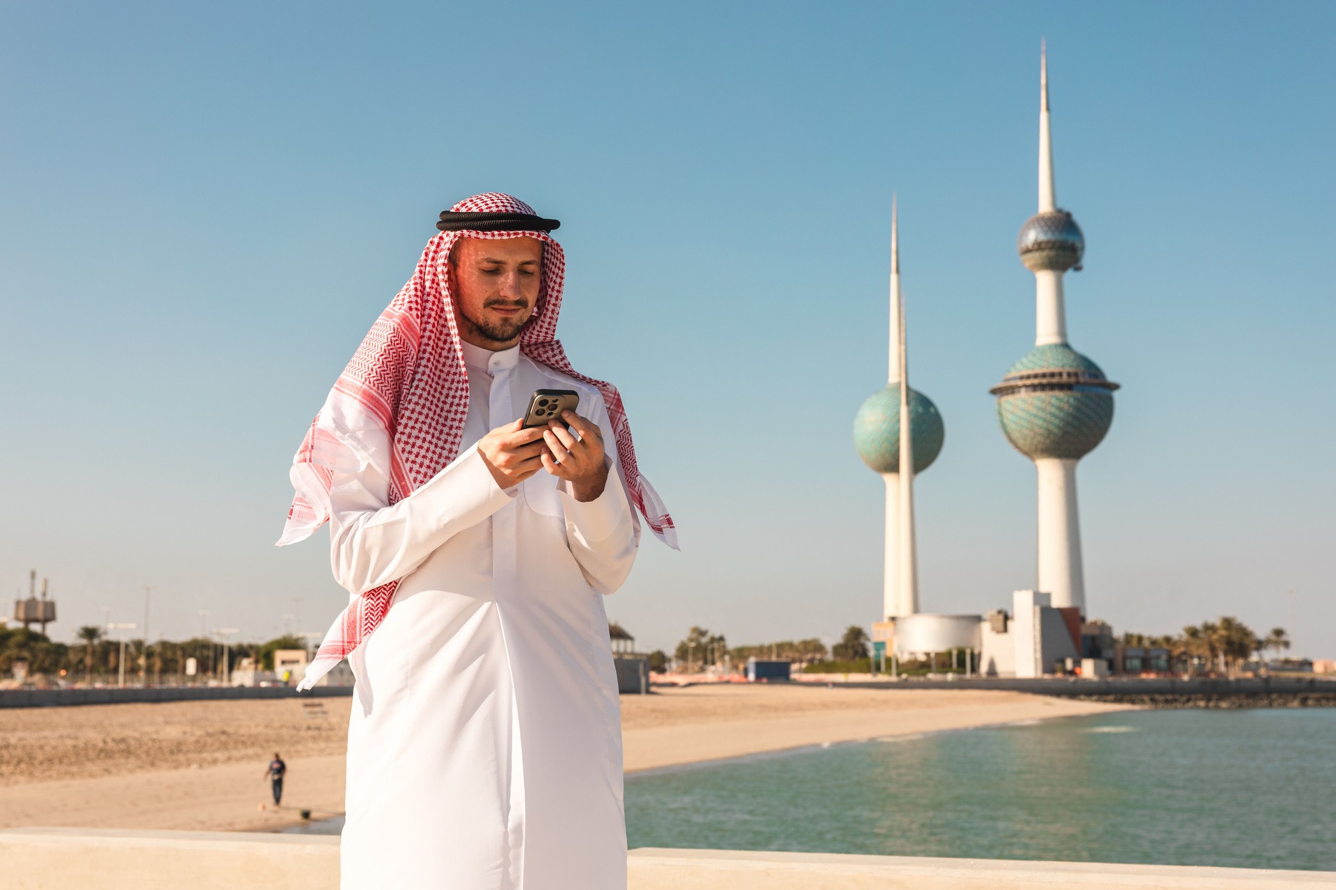 Portrait of a young sheik using his phone in Kuwait city