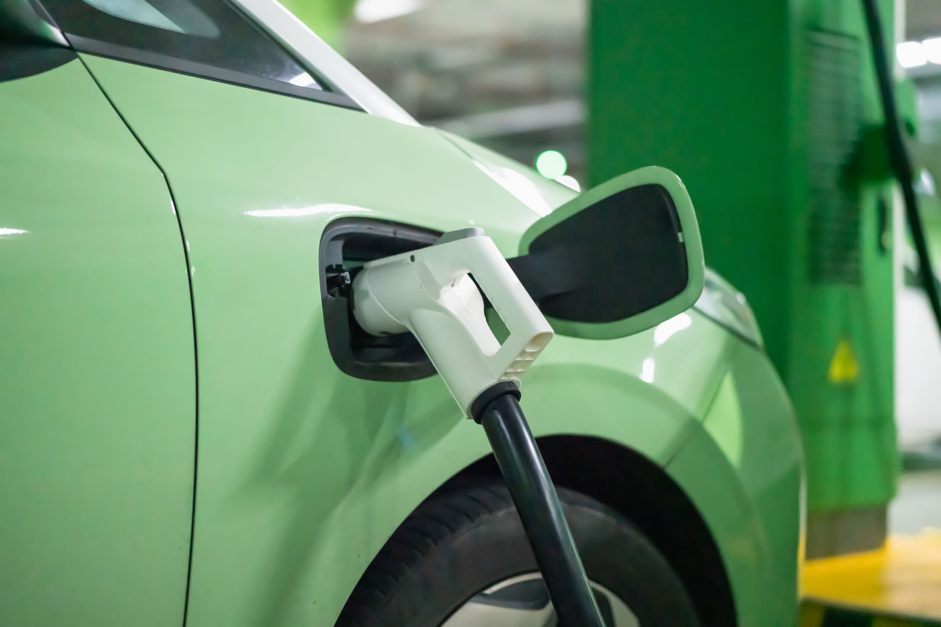 An electric car is fast charging at a super charging station